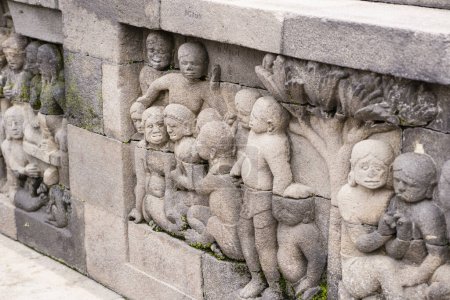 stone bas-relief at Borobudur Buddhist temple in Magelang Regency, near the city of Magelang and the town of Muntilan, in Central Java, Indonesia