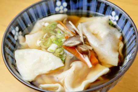 Close-up view of Wonton noodles on wooden table