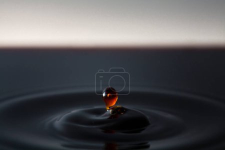 Photo for Drop of dark drink falling and creating circles - Royalty Free Image