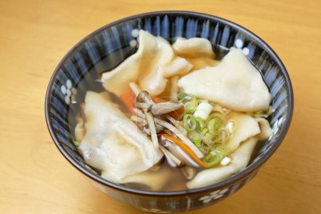 Close-up view of Wonton noodles on wooden table