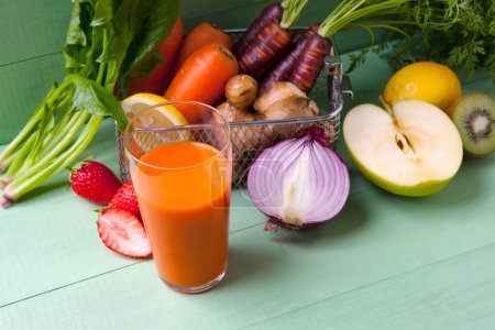 Photo for Fresh juice with vegetables in glass on wooden table - Royalty Free Image