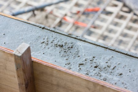 Photo for Worker using cement at construction site, close up - Royalty Free Image