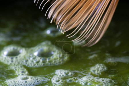 Photo for Matcha broom made of bamboo mixing green matcha tea - Royalty Free Image