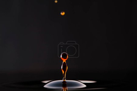 Photo for Drops of dark drink falling and creating circles - Royalty Free Image