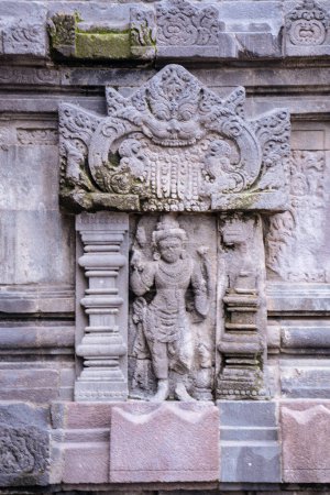 Photo for Stone carving on the wall of Prambanan Hindu temple compound in the Special Region of Yogyakarta, in southern Java, Indonesia, dedicated to the Trimurti, the expression of God as the Creator (Brahma), the Preserver (Vishnu) and the Destroyer (Shiva) - Royalty Free Image