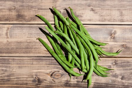 Photo for Fresh green beans in the wooden background. - Royalty Free Image