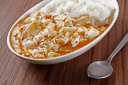 Photo for Boiled rice and spicy tofu cheese with sauce in bowl, closeup - Royalty Free Image