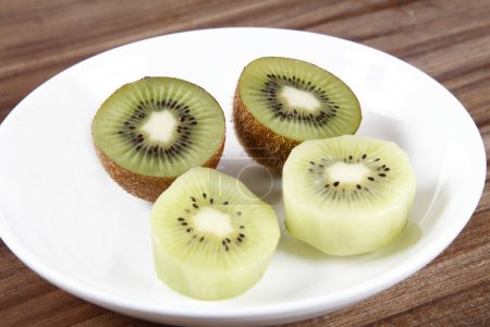 Photo for Fresh sliced kiwi on a white plate - Royalty Free Image