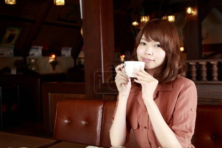 Photo for Redhead Japanese woman working in cafe. Portrait of beauty businesswoman drinking coffee - Royalty Free Image