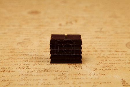 Photo for Close-up view of chocolate pieces on brown vintage table - Royalty Free Image