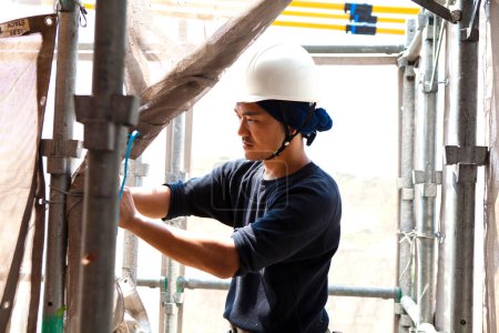 Photo for Portrait of handsome japanese worker posing on the construction site - Royalty Free Image
