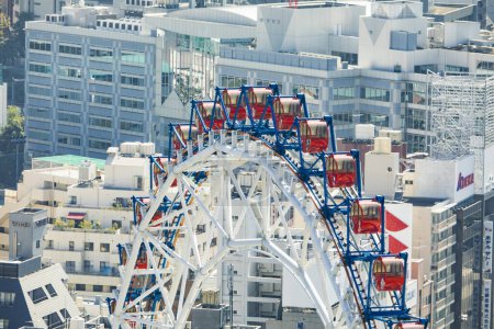 Photo for Bunkyo City, Japan. Tokyo Dome City amusement park, an attractions with Big-O Ferris Wheel and Thunder Dolphin Roller Coaster next to Tokyo Dome. - Royalty Free Image