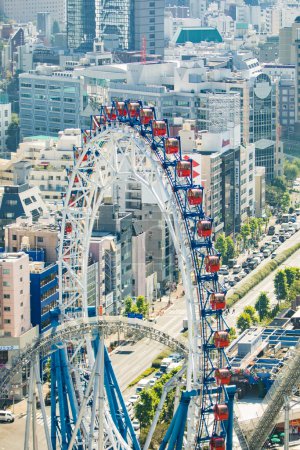 Photo for Bunkyo City, Japan. Tokyo Dome City amusement park, an attractions with Big-O Ferris Wheel and Thunder Dolphin Roller Coaster next to Tokyo Dome. - Royalty Free Image