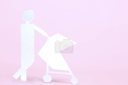 Photo for Baby stroller with paper figure on the background . - Royalty Free Image