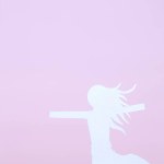 silhouette of woman made from paper isolated on pink background