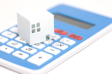 Photo for House model on calculator on background, close up - Royalty Free Image