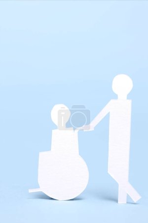 Foto de Papel corte hombre llevar persona en silla de ruedas, ayuda y apoyo concepto de fondo - Imagen libre de derechos