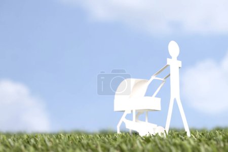 Photo for Cut out paper woman figure with stroller over blue sky background. - Royalty Free Image