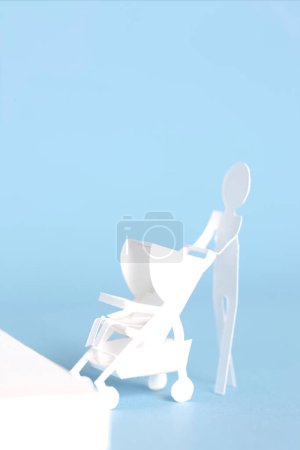 Photo for Cute white paper man with paper Baby stroller - Royalty Free Image