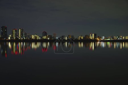 beautiful sunset over the city skyline and reflection in water   