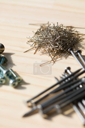 Photo for Screws and nails on a wooden background - Royalty Free Image