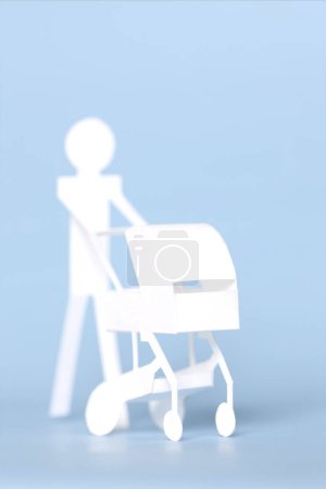 Photo for Small paper man with paper Baby stroller - Royalty Free Image