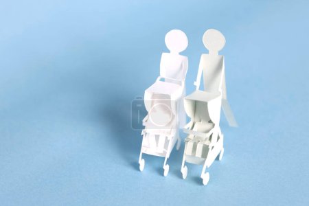 Photo for Maternity concept background with cut out paper women with stroller over blue background - Royalty Free Image
