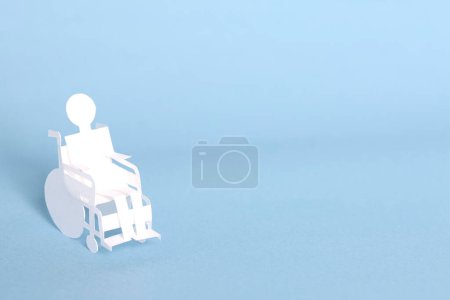 Photo for Paper cut out man on wheelchair - Royalty Free Image