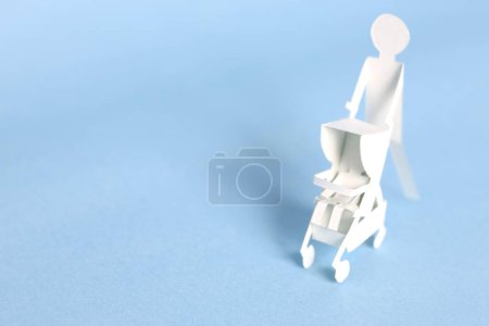 Photo for White paper man with paper Baby stroller - Royalty Free Image