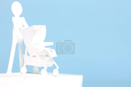 Photo for Paper man with paper Baby stroller - Royalty Free Image