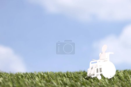 Photo for Cut out paper human figure on wheelchair - Royalty Free Image