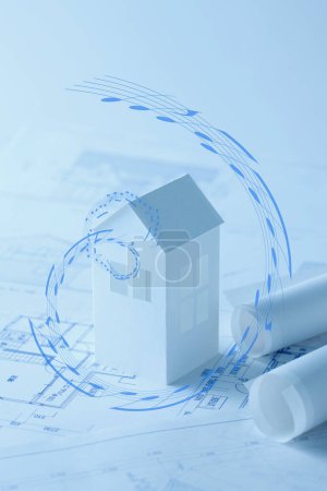 Photo for House model and blueprints on blue - Royalty Free Image
