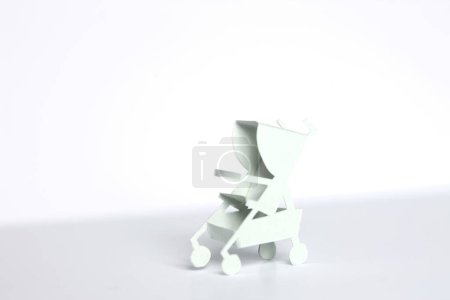  white paper Baby stroller on background, close up
