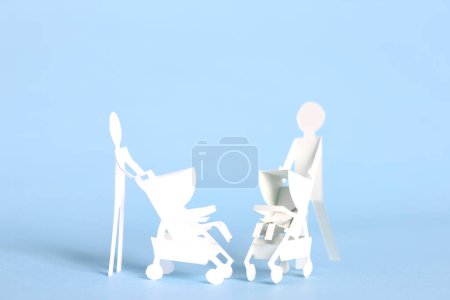 Photo for Maternity concept background with cut out paper women with stroller over blue background - Royalty Free Image