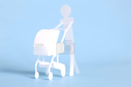 Photo for Paper man with cute white paper Baby stroller - Royalty Free Image