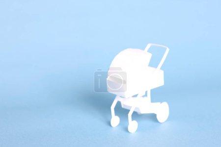  white paper Baby stroller on background, close up
