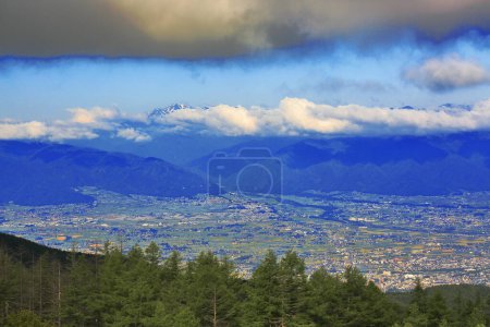 Foto de Panorama de la ciudad en valle montañoso y nubes en cielo azul - Imagen libre de derechos