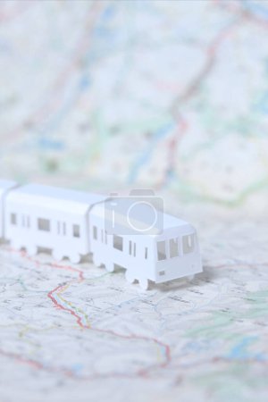 Photo for Miniature  white train and tourist map on a background - Royalty Free Image