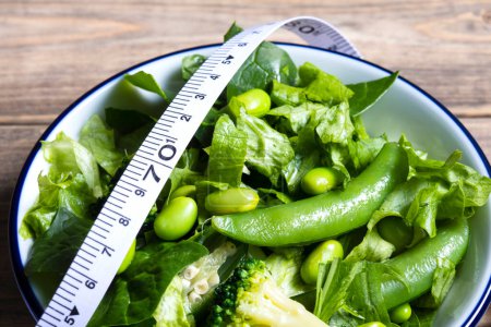 Photo for Healthy food. Tape measure, green salad, fresh green broccoli with spinach and edamame beans - Royalty Free Image