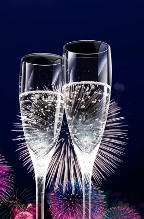 Photo for Glasses of champagne with fireworks on the background of a night sky. new year celebration concept. - Royalty Free Image