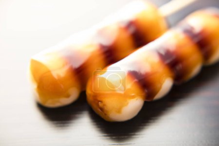 Photo for Dango, Japanese sweet dumplings made from rice flour mixed with uruchi rice flour and glutinous rice flour. It is different from the method of making mochi, which is made after steaming glutinous rice. - Royalty Free Image