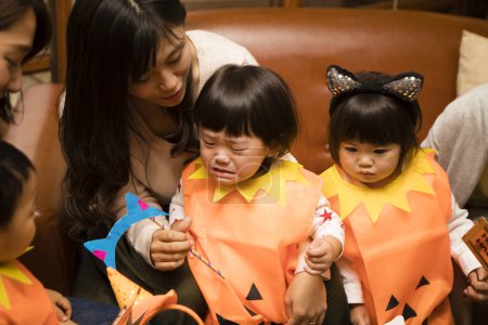 Photo for Asian young mothers and their cute little kids celebrating Halloween - Royalty Free Image