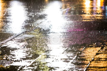 Photo for Wet road of city street with rain drops at night - Royalty Free Image