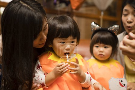 Photo for Asian young mothers and their cute little kids celebrating Halloween - Royalty Free Image