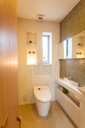 Photo for A bathroom with a toilet, sink, and mirror - Royalty Free Image