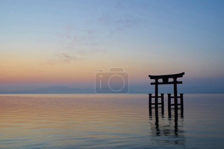Photo for Shirahige Jinjia at sunset. Torii in Lake Biwa, Shirahige Shrine, Takashima, Shiga, Japan - Royalty Free Image