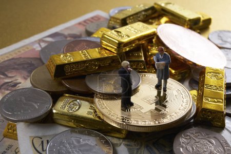 Photo for Miniature figures of businessmen standing on stack of coins, bitcoins and gold bars - Royalty Free Image