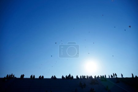 Photo for Group of people looking at hot air balloons flying in sky - Royalty Free Image