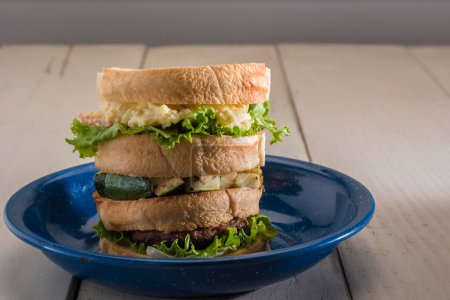 Photo for Pile of homemade sandwiches with chicken breast, lettuce, cheese, eggs and shrimps - Royalty Free Image