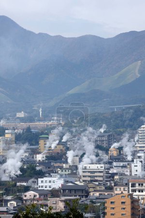 Beautiful scenery of Beppu cityscape with Steam drifted from public bath.